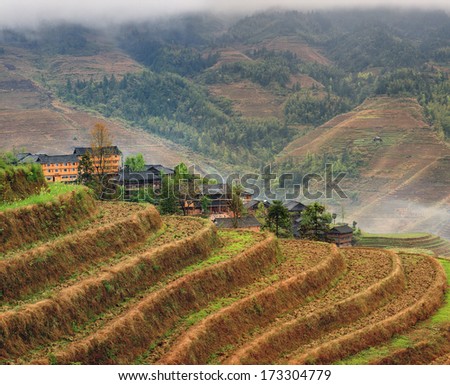 Yao Dazhai, Longsheng, near town of Guilin, Guangxi Province, China. Hillside rice terraces, rice fields in  highlands of Asia. Spring fog in mountains of southwestern China, rice terraces, farmhouses