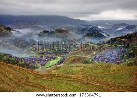 Village Dazhai, near Guilin, Guangxi, China.  Rural China, peasant village in countryside, mountain region, rice paddies. Rice terraces in highlands of southwestern China, farmhouses, ethnic village.