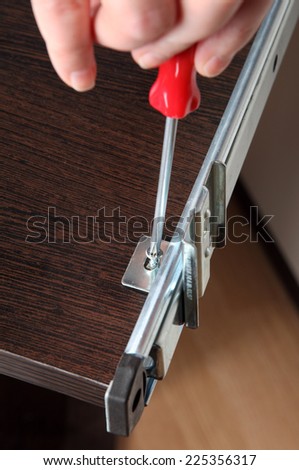 Furniture mounting, installation running tracks,  fitting drawer slide rear mounting bracket,  fixing screw using a manual screwdriver.