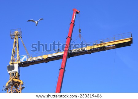 St. Petersburg, Russia - October 29, 2014: Mounting works, installation of a tower crane, fixed to tower section.