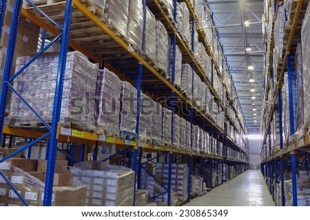St. Petersburg, Russia - November 21, 2008: Narrow passageway goods warehouse with pallet storage system, shelves shelves.