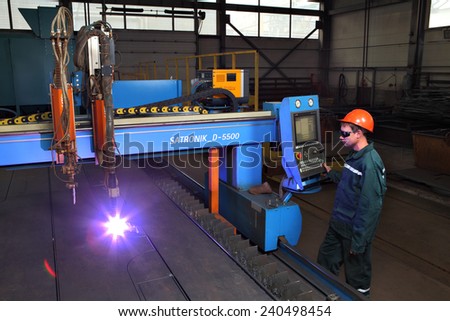 Saint  Petersburg, Russia - October 10, 2014: The metal factory, a worker operates a system of thermal cutting of metal sheets, plasma cutting machine for sheet steel, industrial equipment.