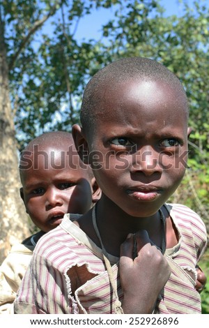 Meserani Snake Park, Arusha, Tanzania - February 14, 2008: Two unidentified children, a black boy about 8 years old, and black girl about 4 years, the villagers maasai.
