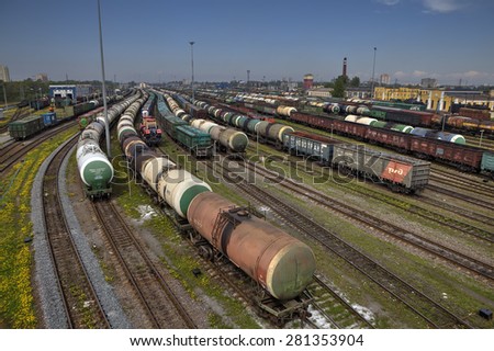St. Petersburg, Russia - May 22, 2015: big railway cargo station junction with lot of trains and track lines, Freight Station with trains, Freight train pulling several box and tank cars on summer day