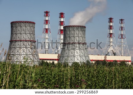 St. Petersburg, Russia - July 9, 2015: Modern combined heat and power plant, electrical power station, structural steel cooling tower, and Industrial chimneys, blue sky, sunny day