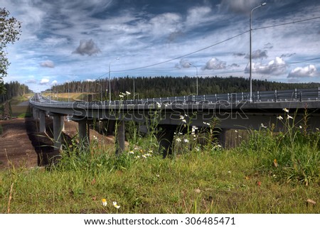 Saint Petersburg, Russia - August 7, 2015: Overpass speed highway in a conservation area in Leningrad region, the route St. Petersburg - Sortavala, steel bridge crosses river Smorodinka.