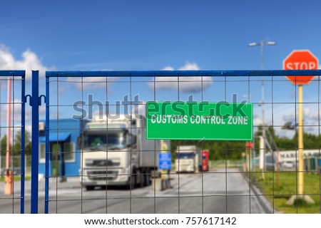 Trucks pass through the checkpoint of the customs logistics terminal.