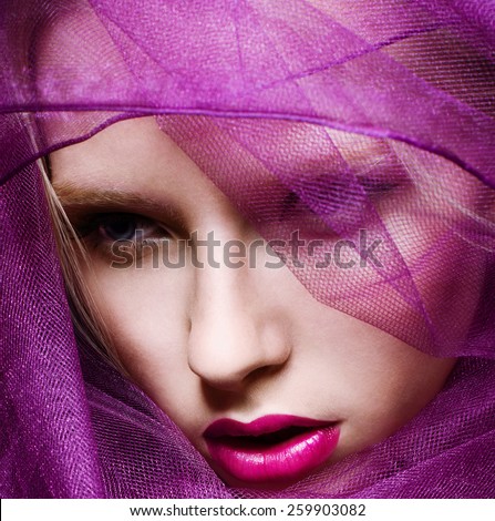 Beautiful fashion model face with purple veil