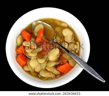 Lima bean soup on a black background.