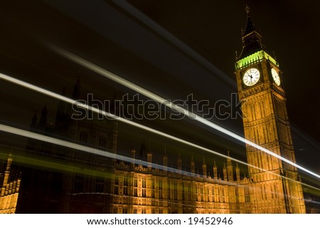 Westminster Tower/Big Ben in London, UK at night with light trails of passing vehicles