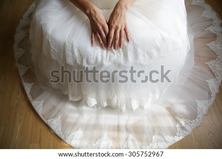 sitting bride with her hands