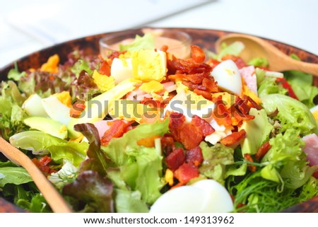 Healthy Salad with Dressing in Wood Bowl