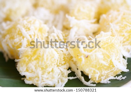 Thai dessert for rituals and eating. Flour stuffed with sweet coconut, and grated coconut topping on plate.