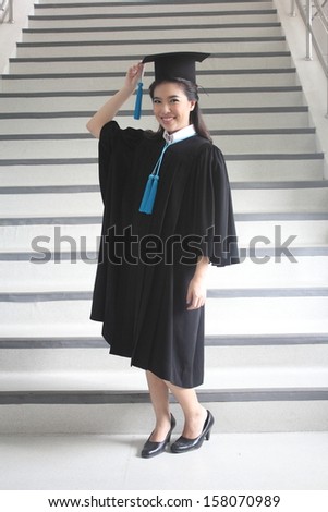 female graduation portrait with stair