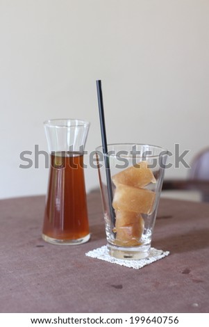 Glass of ice tea and ice tea cubes