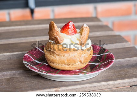 Fresh cream puff with whipped cream and strawberries