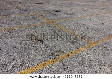 yellow lines on dirty bright asphalt