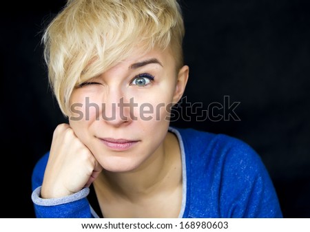 portrait of young woman with one eye shut