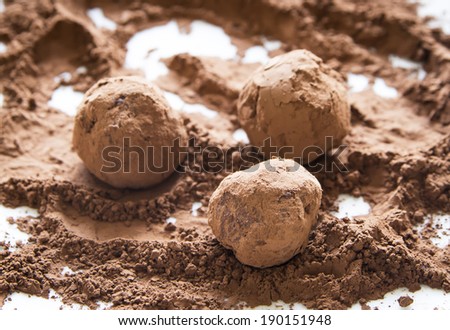 rolling homemade chocolate truffles in cocoa powder