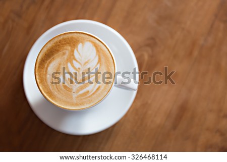 cup of cappuccino on the wooden table background