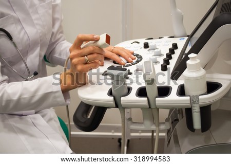 An ultrasound diagnostic specialist working at the ultrasound device