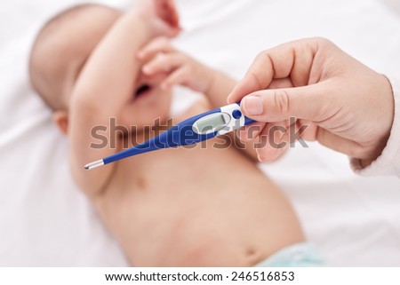 Fever, measuring temperature for little baby child