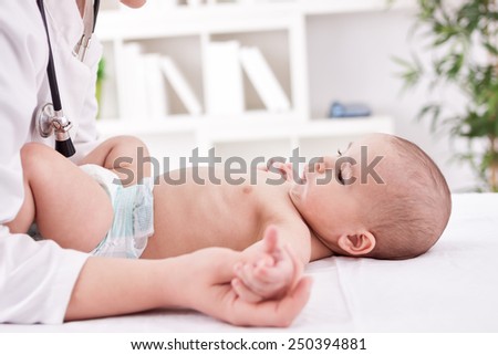 Female doctor practicing with baby child