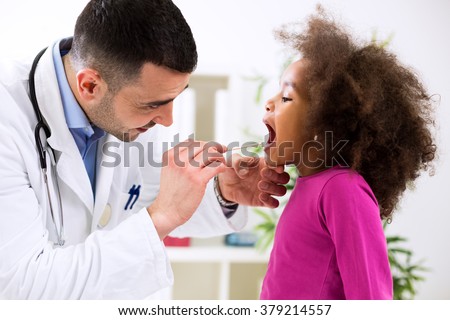 Doctor pediatrician examining cute smiling african girl, throat sick