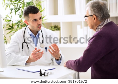 Doctor talking with old patient