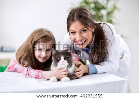Kid with pet cat at the veterinary doctor
