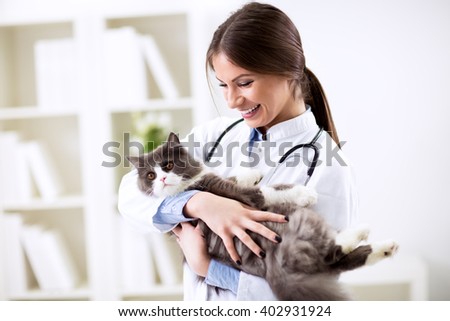 Happy smiling vet with patient at work