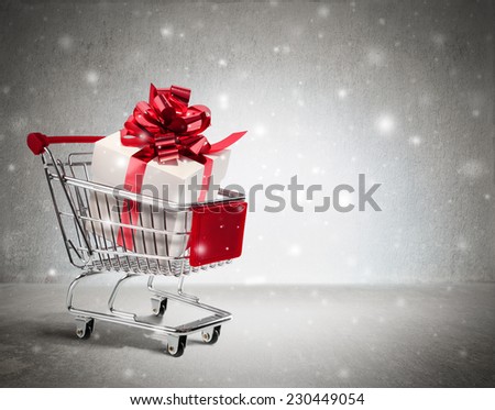 christmas gift in cart - wall and snow