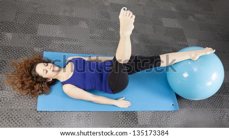 woman doing pilates ball on the floor