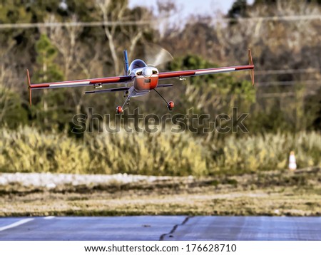 January 25th 2014 Largo Florida. A remote control airplane does a fly-by and lands on the runway at Largo Remote Control Air Park.