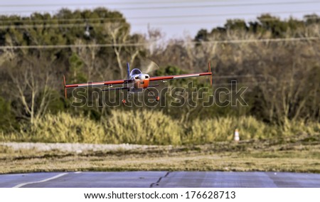 January 25th 2014 Largo Florida. A remote control airplane does a fly-by and lands on the runway at Largo Remote Control Air Park.