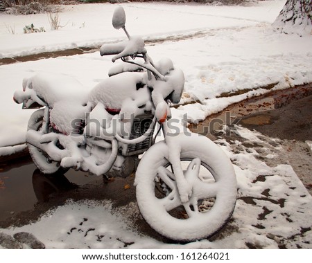 A motorcycle covered in snow