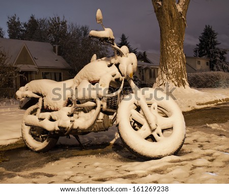 A motorcycle covered in snow.