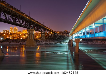 Bridges at night over a river covered in ice flows
