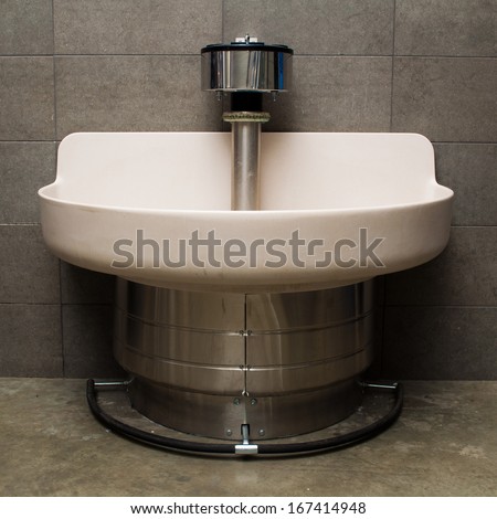 Large hands free wash station with a foot pedal in an industrial building