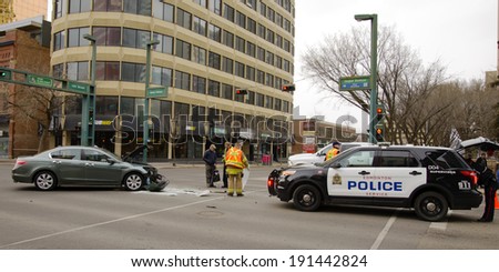 EDMONTON, AB CANADA - MAY 3, 2014: A car accident in an downtown intersection with a police vehicle on site in Edmonton on May 3, 2014.