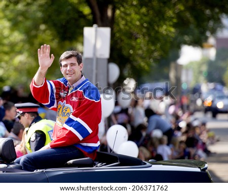 EDMONTON, AB, CANADA-July 18, 2014:  Edmonton Mayor Don Iveson wearing an Edmonton Oil Kings jersey as seen in the K-Days Parade on July 18th, 2014.