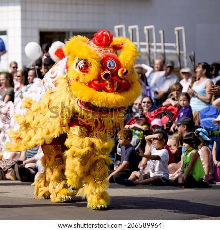 EDMONTON, AB, CANADA-July 18, 2014:  People performing in Chinese dragon costumes as seen in the K-Days Parade on July 18th, 2014.