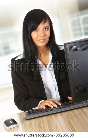 Smiling young businesswoman working in office