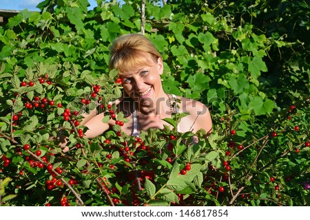Portrait of the woman of average years in a garden