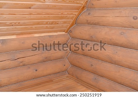Timbered laying of the wooden house. Fragment of a corner and ceiling