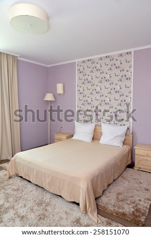 Interior of a bedroom of a double hotel room in light tones. Bedroom