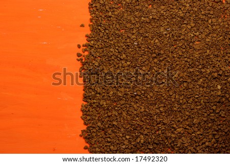 photo background with soluble coffee granules on a orange