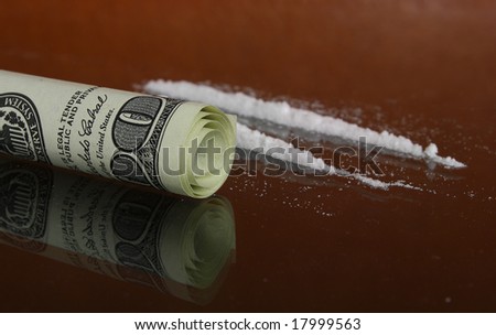 cocaine and one hundred dollars on a dark background