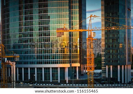 Construction of new Moscow business center. Crane near two skyscrapers.
