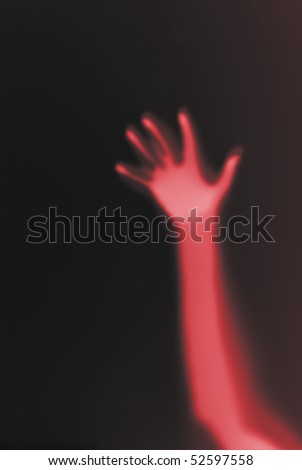 red hand through frosted glass